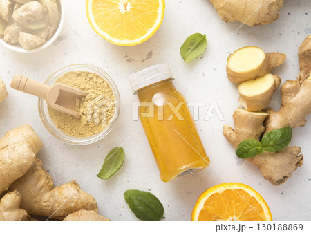 Immune ginger and orange energy shot drink with ginger root and grounded powder. 130188869