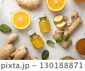 Immune turmeric energy shot drink with fresh raw ginger root and oranges on light background. 130188871