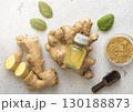 Bottle of immune ginger energy shot drink with ginger root and grounded powder on light background. 130188873