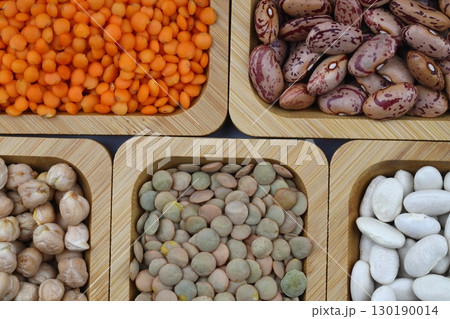 Different type of raw dry legumes composition. lentils, red lentils, chickpeas and kidney beans. Mix organic legume concept. Different type of raw dry legumes composition. lentils, red lentils, chickpeas and kidney beans. Mix organic legume concept. 130190014
