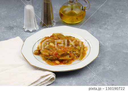 Homemade stewed green beans, tomatoes, garlic with olive oil. Zeytinyagli fasulye traditional food. Turkish cuisine. Homemade stewed green beans, tomatoes, garlic with olive oil. Zeytinyagli fasulye traditional food. Turkish cuisine. 130190722