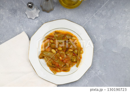 Homemade stewed green beans, tomatoes, garlic with olive oil. Zeytinyagli fasulye traditional food. Turkish cuisine. Homemade stewed green beans, tomatoes, garlic with olive oil. Zeytinyagli fasulye traditional food. Turkish cuisine. 130190723