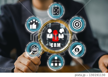 Business professional interacting with a CRM interface, showcasing customer relationship management and data analysis tools. 130191130