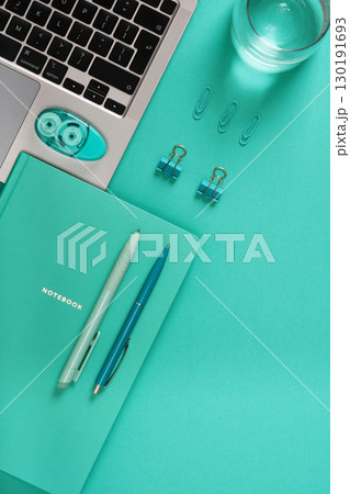 Turquoise desk with laptop, notebook and stationery. Space for your text. Study, planning, and productivity workplace. Turquoise desk with laptop, notebook and stationery. Space for your text. Study, planning, and productivity workplace. 130191693