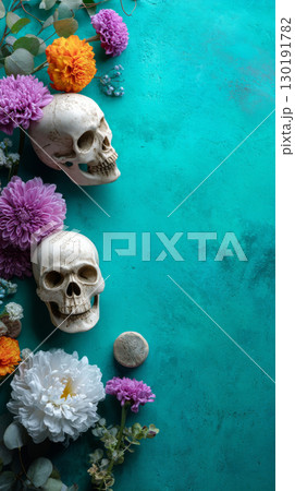 Vibrant turquoise backdrop featuring decorative skulls and colorful flowers for Day of the Dead celebration 130191782
