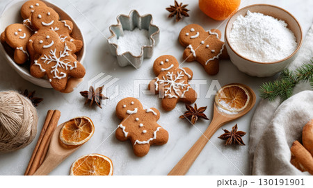 Freshly baked gingerbread men cookies surrounded by festive decorations on a cozy Christmas table Freshly baked gingerbread men cookies surrounded by festive decorations on a cozy Christmas table 130191901