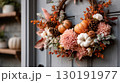 Beautiful autumn wreath adorned with fall foliage and pumpkins for seasonal home decor 130191977