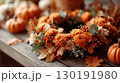 Beautiful Thanksgiving wreath adorned with golden autumn leaves and seasonal flowers in a cozy yard setting 130191980