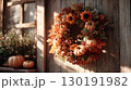 Thanksgiving wreath adorned with pumpkins and vibrant autumn leaves enhances holiday spirit in cozy setting 130191982