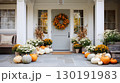 Elegant autumn entrance with a harvest wreath and colorful pumpkins for Thanksgiving celebration 130191983