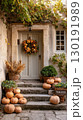 Elegant entrance adorned with a harvest wreath and pumpkins for Thanksgiving celebration 130191989