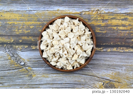 handmade manti (turkish ravioli type dumplings) on wooden   bowl, before cooking 130192040