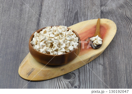 handmade manti (turkish ravioli type dumplings) on wooden bowl, before cooking handmade manti (turkish ravioli type dumplings) on wooden bowl, before cooking 130192047