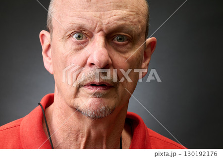 Closeup portrait of a senior man making funny faces Closeup portrait of a senior man making funny faces 130192176