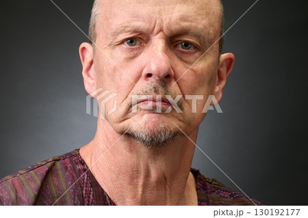 Closeup portrait of a senior man making funny faces Closeup portrait of a senior man making funny faces 130192177