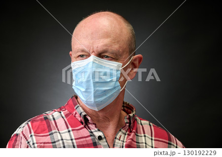 Closeup portrait of a elderly man in studio wearing a facial mask Closeup portrait of a elderly man in studio wearing a facial mask 130192229