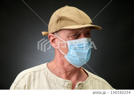 Closeup portrait of a elderly man in studio wearing a facial mask Closeup portrait of a elderly man in studio wearing a facial mask 130192254