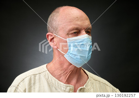 Closeup portrait of a elderly man in studio wearing a facial mask Closeup portrait of a elderly man in studio wearing a facial mask 130192257