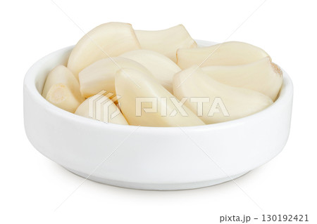 garlic cloves in ceramic bowl isolated on white background close up 130192421