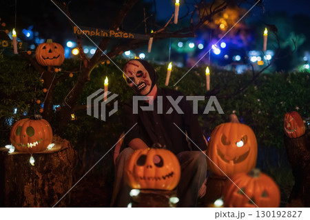 Scary mask devil ma sit by pumpkin lantern with light up candle 130192827