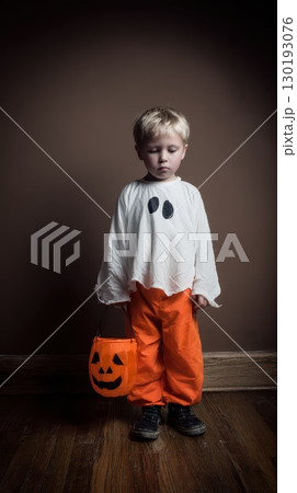 Young child dressed as a ghost for Halloween fun 130193076