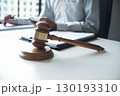 Legal justice man working on desk reading supportive documents to determine the consulting case 130193310