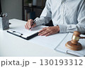 Legal justice man working on desk reading supportive documents to determine the consulting case 130193312