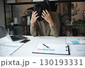 Overworked stressed businessman has headache pain while working in office. 130193331