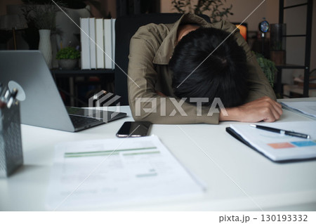 Overworked stressed businessman has headache pain while working in office. 130193332