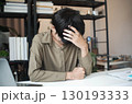 Overworked stressed businessman has headache pain while working in office. 130193333