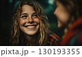 Young woman smiling in a natural, rustic setting 130193355
