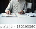 Legal justice man working on desk reading supportive documents to determine the consulting case 130193360