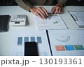 Businessman reading report in office desk analyze data for plan project 130193361