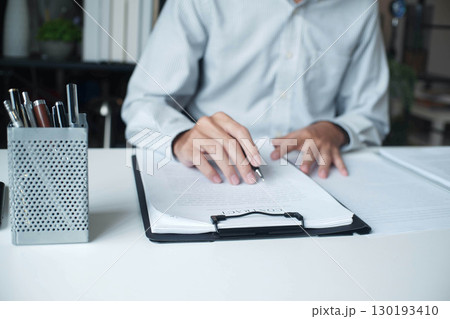 Businessman reading contract in the office. 130193410