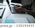 Businessman, entrepreneur, accountant working on financial report on desk using laptop. 130193435