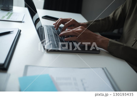 Businessman, entrepreneur, accountant working on financial report on desk using laptop. 130193435