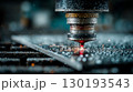 A laser cutting a metal sheet in an industrial factory 130193543