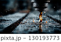 A drilling machine cutting into a metal plate 130193773