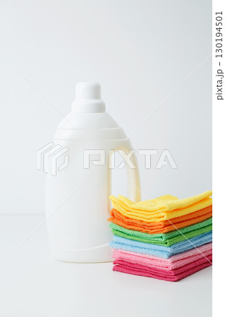 Laundry detergent branding mock up and clean stack of colorful towels. Household cleaning and hygiene concept packaging 130194501