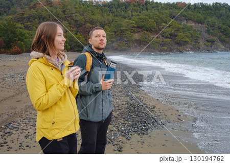 Couple drinks tea by winter sea shore 130194762