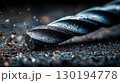 A large drill bit with metal shavings and dust 130194778