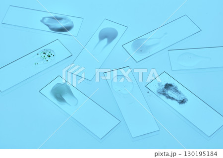Various cosmetic products on slides on a blue background. 130195184