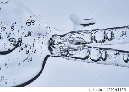 A pipette with cosmetic serum on a blue background. 130195186