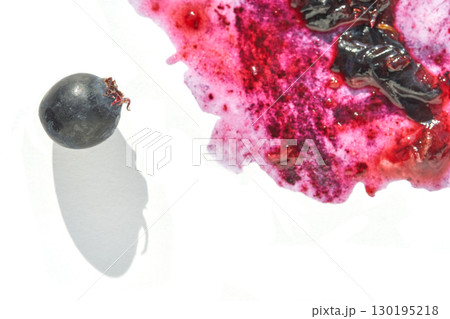 Isolated black grape with vibrant red and purple juice splash on white 130195218