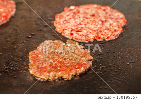 burger patties fried, selective focus burger patties fried, selective focus 130195357