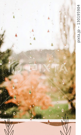 Colorful autumn trees with warm hues stand beneath falling rain droplets. The droplets vary in color, enhancing the cozy ambiance of a rainy fall day 130195984