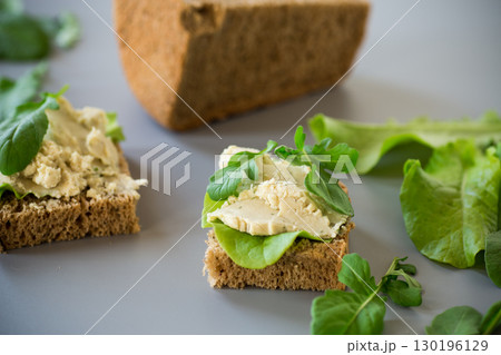 Appetizing sandwich with greens and fish spread Appetizing sandwich with greens and fish spread 130196129