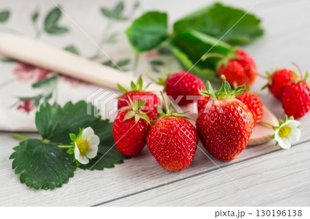 Ripe strawberries on a light wooden table 130196138