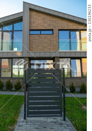 Modern townhouse with a secure gate and fence Modern townhouse with a secure gate and fence 130196233
