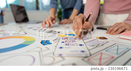 Hands on UX and UI Design. Team members sketching ideas and wireframes on a collaborative project. Hands on UX and UI Design. Team members sketching ideas and wireframes on a collaborative project. 130196671